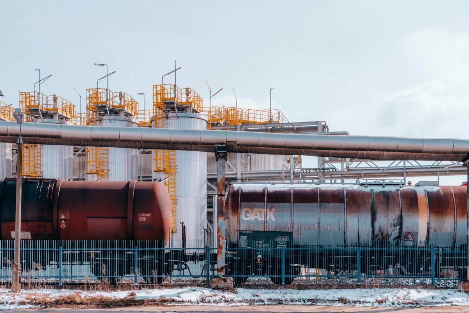 Fuel train and refinery tanks in Trzebinia, Poland, showcasing industrial energy infrastructure.