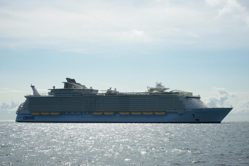 A large cruise ship sailing across the open sea under a clear sky, highlighting maritime travel.