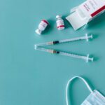 Syringes, vaccine vials, and face mask ready for COVID-19 vaccination.