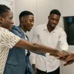 A diverse group of professionals engaging in a team-building exercise in an office environment.