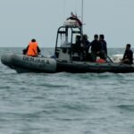 people riding on black inflatable boat during daytime