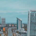 cars on road near high rise buildings during daytime