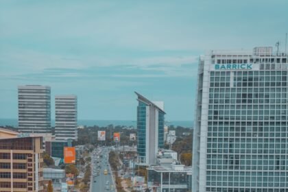 cars on road near high rise buildings during daytime