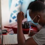 Journalist working at computer in a newsroom