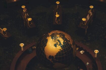 Aerial view of a glowing globe at a circular reception desk with ambient lighting.