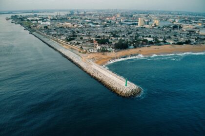 Aerial shot capturing the coastline and urban sprawl of Abidjan, Côte d'Ivoire.