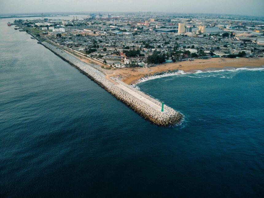 Aerial shot capturing the coastline and urban sprawl of Abidjan, Côte d'Ivoire.