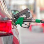 a gas pump is connected to a car at a gas station