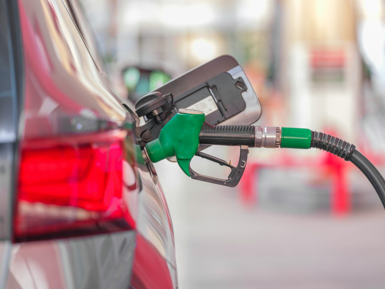 a gas pump is connected to a car at a gas station