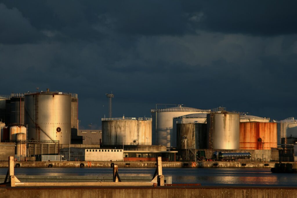 a large industrial area with a body of water in front of it