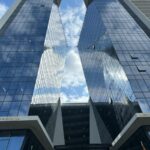 A vibrant view of contemporary skyscrapers with glass facades under a bright sky in Maputo, Mozambique.
