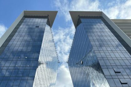A vibrant view of contemporary skyscrapers with glass facades under a bright sky in Maputo, Mozambique.