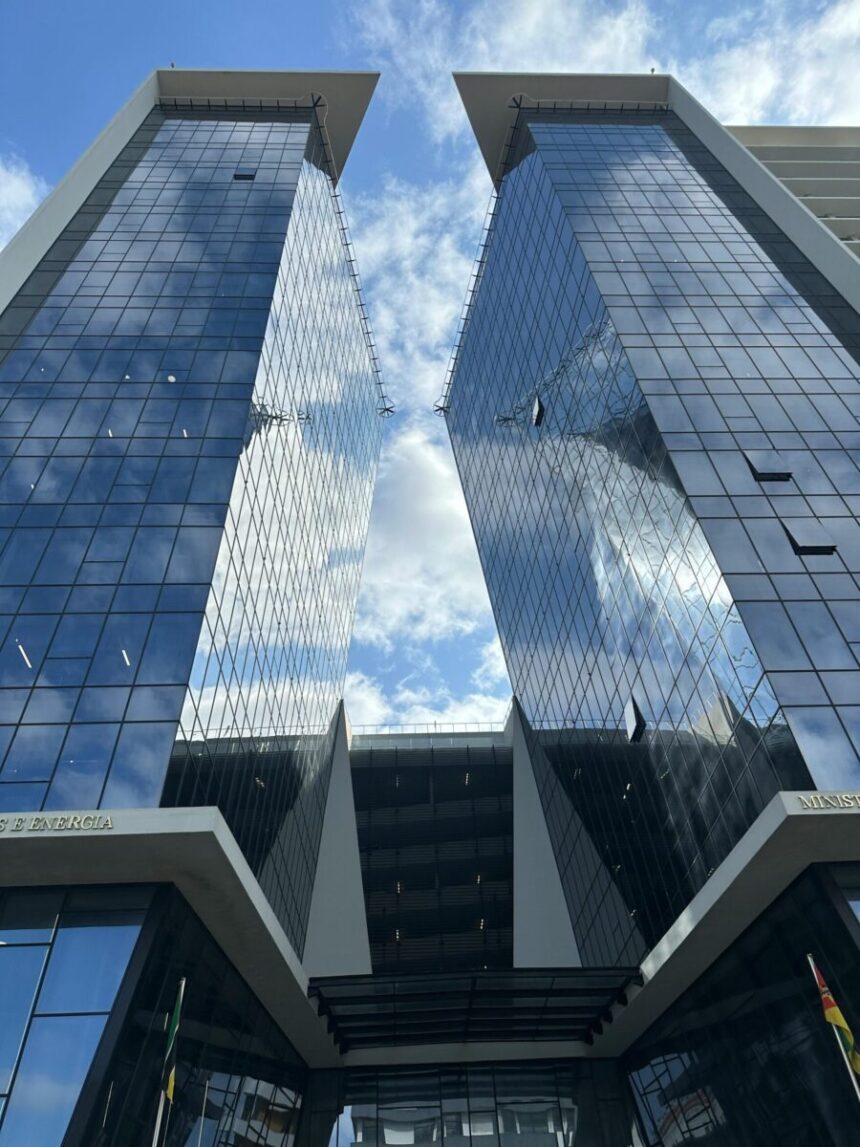 A vibrant view of contemporary skyscrapers with glass facades under a bright sky in Maputo, Mozambique.