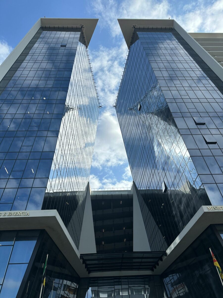 A vibrant view of contemporary skyscrapers with glass facades under a bright sky in Maputo, Mozambique.