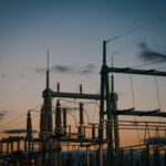 a group of power lines with a sky in the background