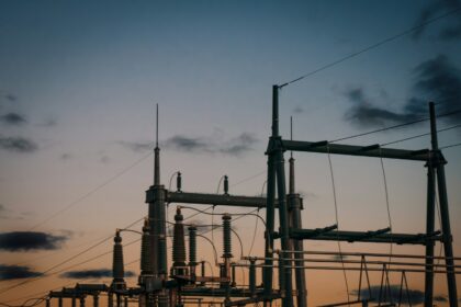 a group of power lines with a sky in the background