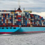 blue and red cargo ship on sea during daytime