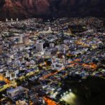 A stunning aerial view of Cape Town city lights at night against Table Mountain.