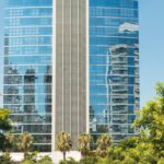 A modern glass skyscraper reflecting the cityscape in Porto Alegre, Brazil.