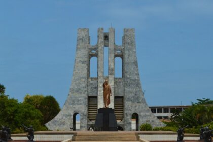 a statue of a person standing in front of a building