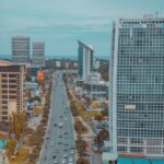 cars on road near high rise buildings during daytime